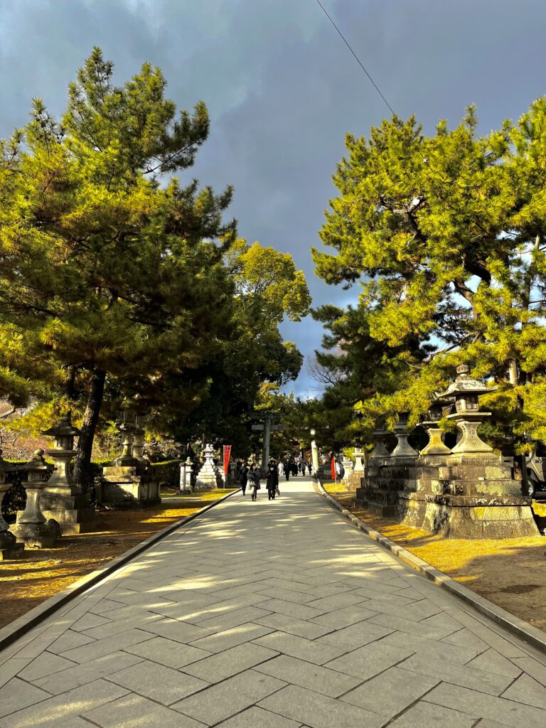 Stone paved path flanked by stone lanterns